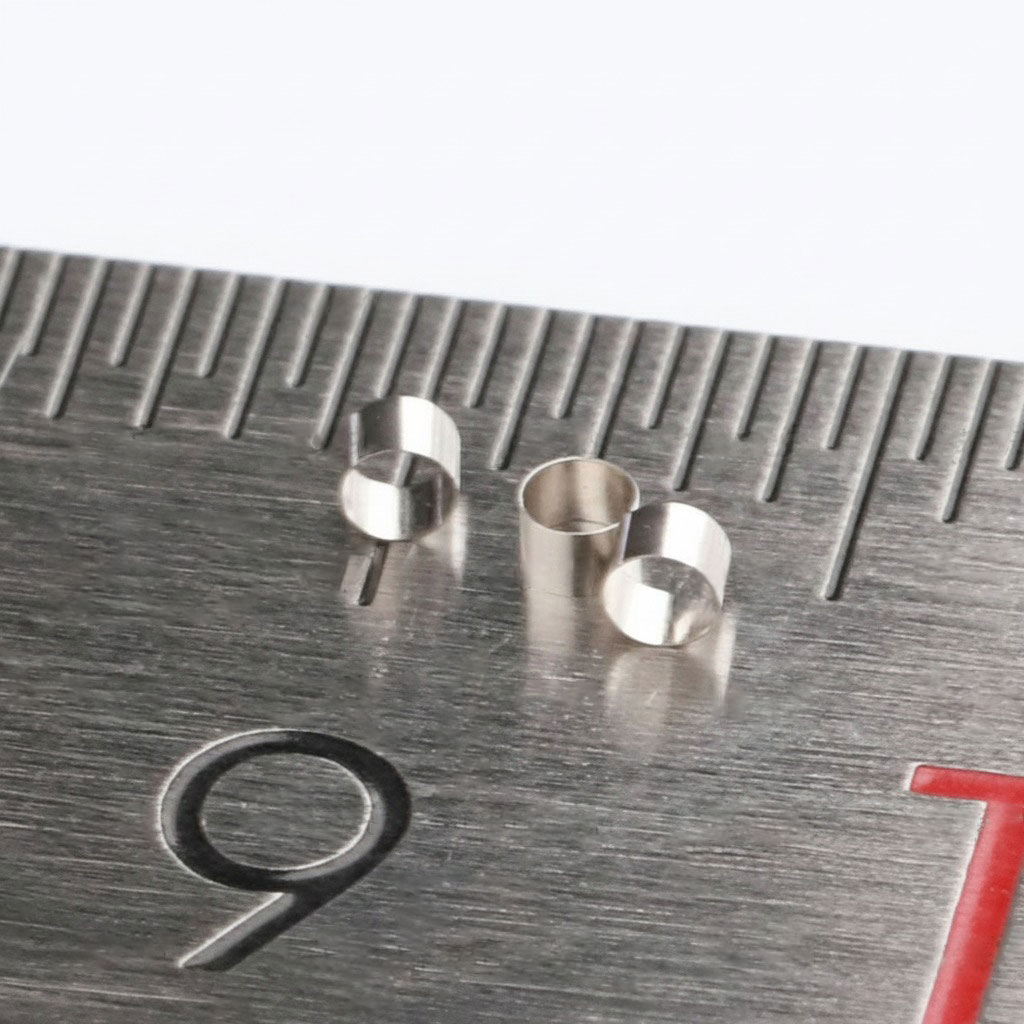 Platinum-iridium marker bands shown under magnification, revealing their clean edges, uniform shape, and high-quality finish essential for medical device reliability.