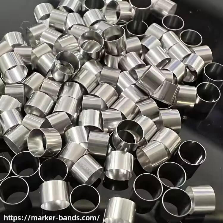 Pure tantalum marking bands with tantalum rings for radiopaque visibility in catheter applications.