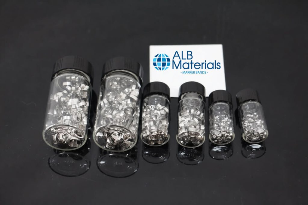Close-up image of implantable radiopaque marker bands, precision-engineered from biocompatible metals such as platinum or tantalum, designed to provide long-term visibility under X-ray imaging for implanted medical devices like stents or catheters.